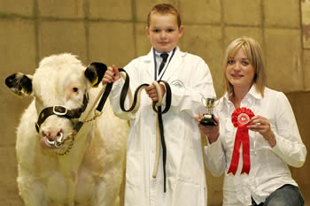 Sam Martin, Newtownards won the NI Belgian Blue Club's Young Handler Competition for the 8-12 age group and judge of the event Rachel Parry, Lancaster is pictured presenting the award.